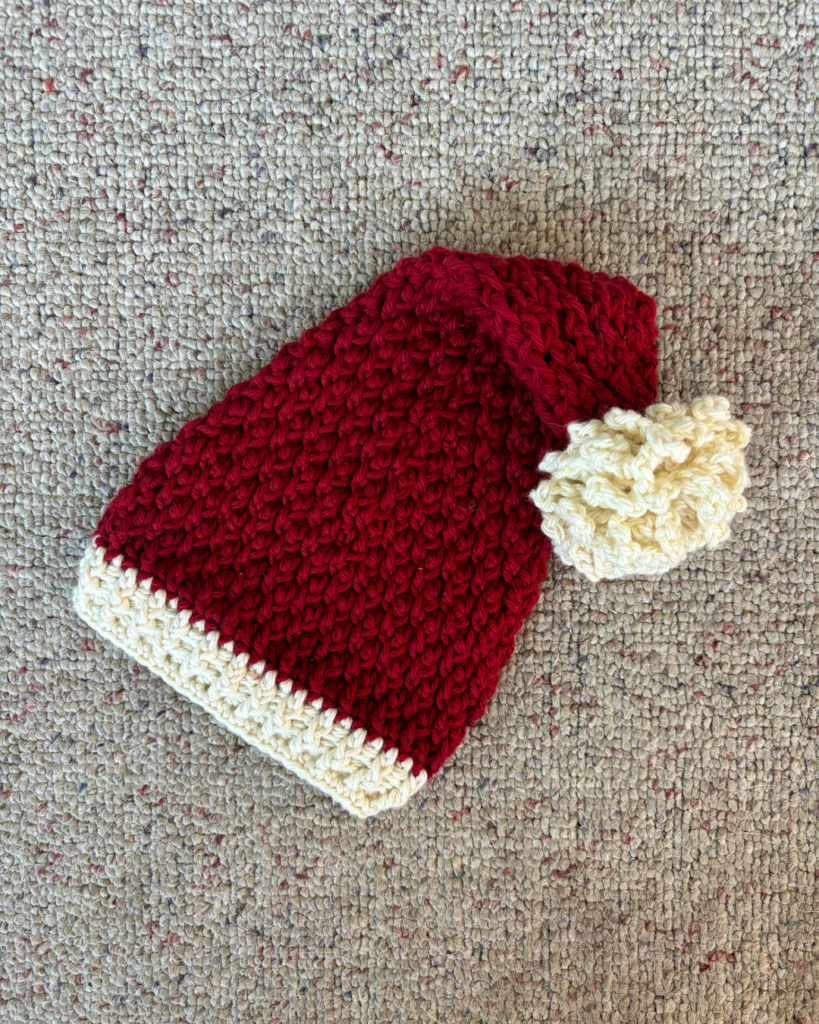 festive crochet baby elf shape hat and holiday Santa-inspired colors
