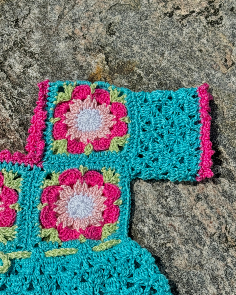 Pink picot edging detail on handmade crochet baby dress