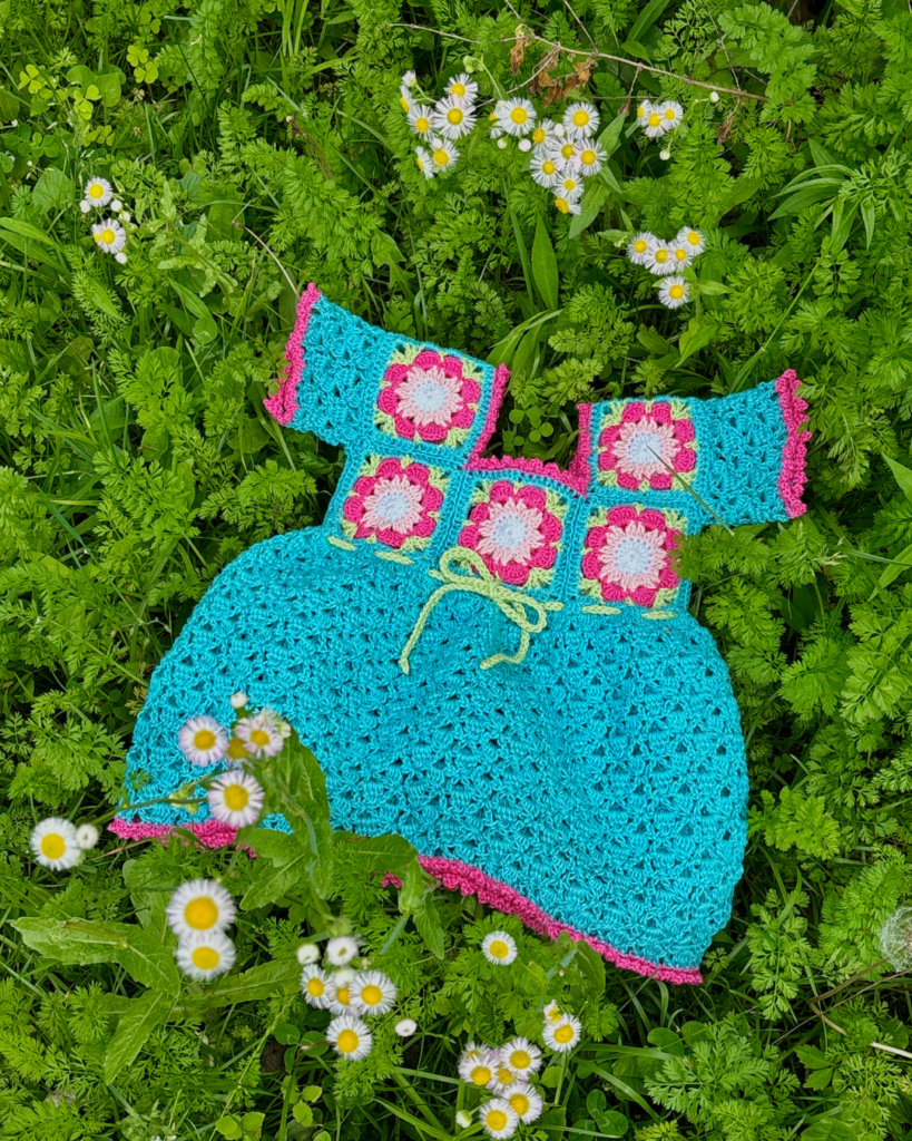 Tropical-inspired crochet baby dress made with floral granny squares
