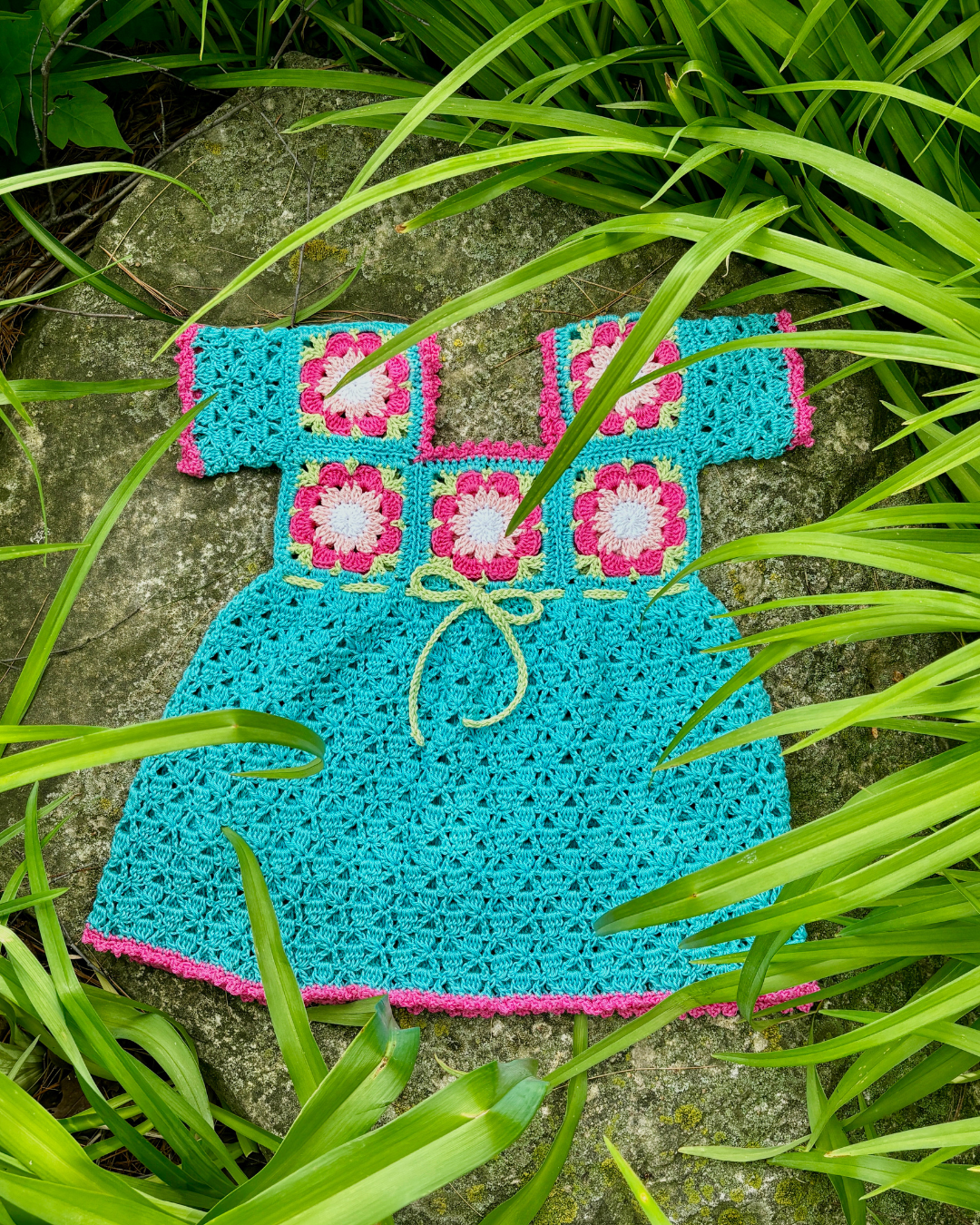 Tropical-inspired crochet baby dress made with floral granny squares