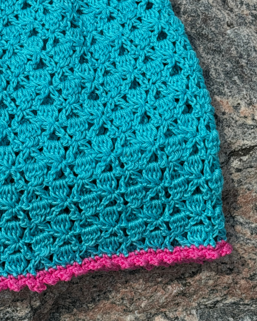 Pink picot edging detail on handmade crochet baby dress