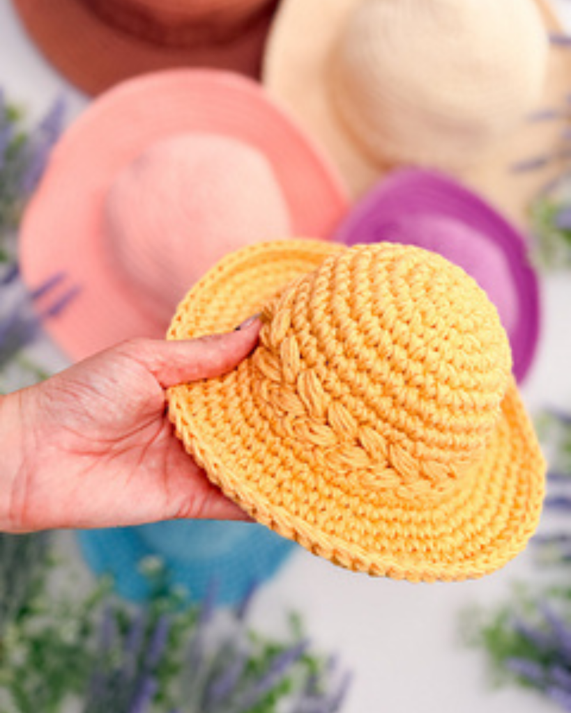Crochet sun hat worked with wheat stitch texture and a wide brim