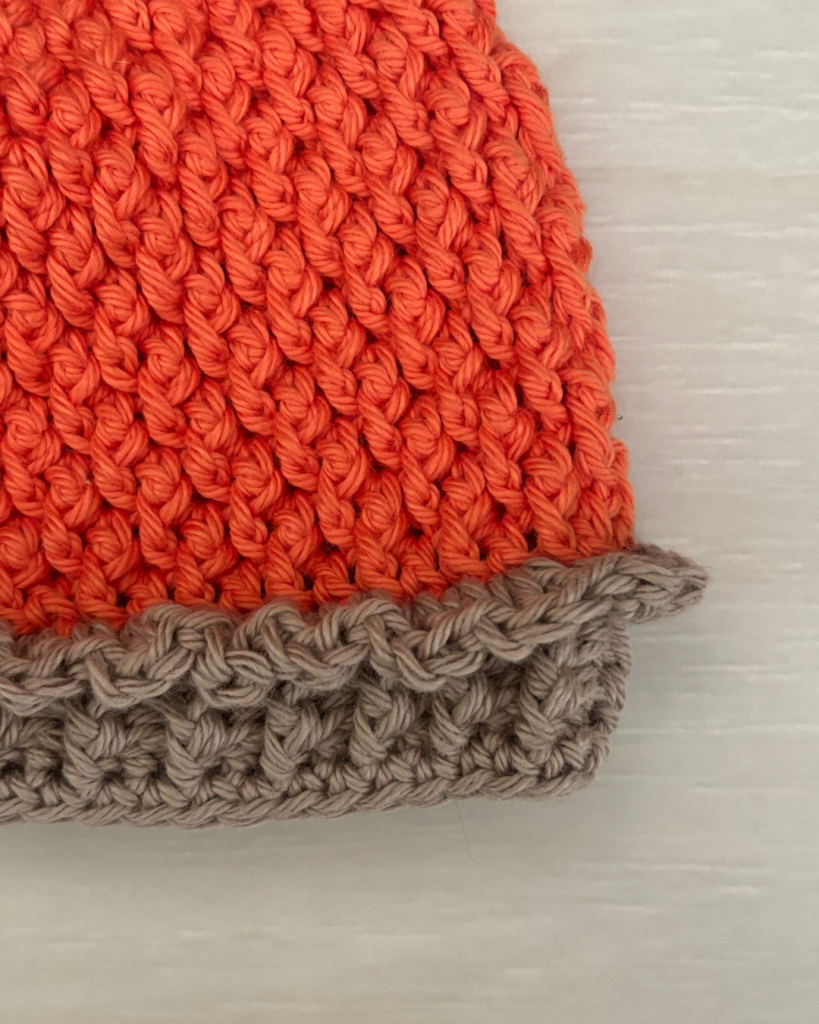 Close-up of the ruffled pie crust edge and ribbed brim on the Pumpkin Pie Baby Hat