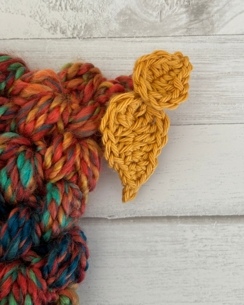 Two crocheted leaves attached to the top of the Woodland Wanderer toddler hat