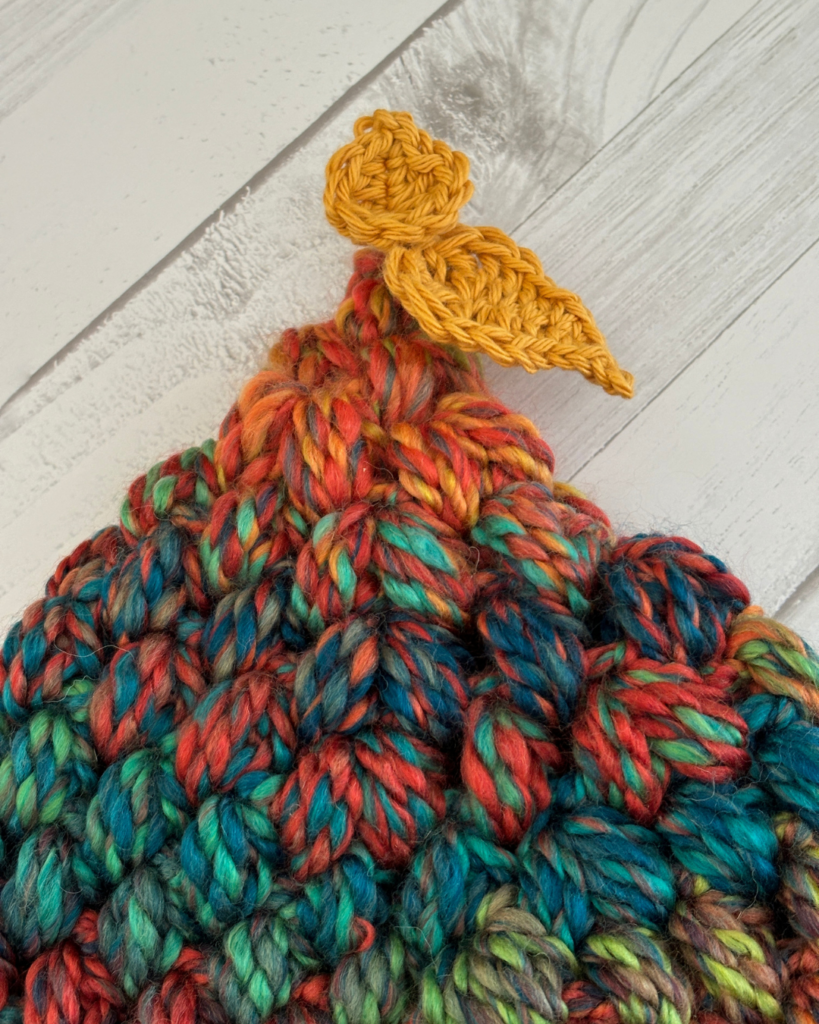 Two crocheted leaves attached to the top of the Woodland Wanderer toddler hat