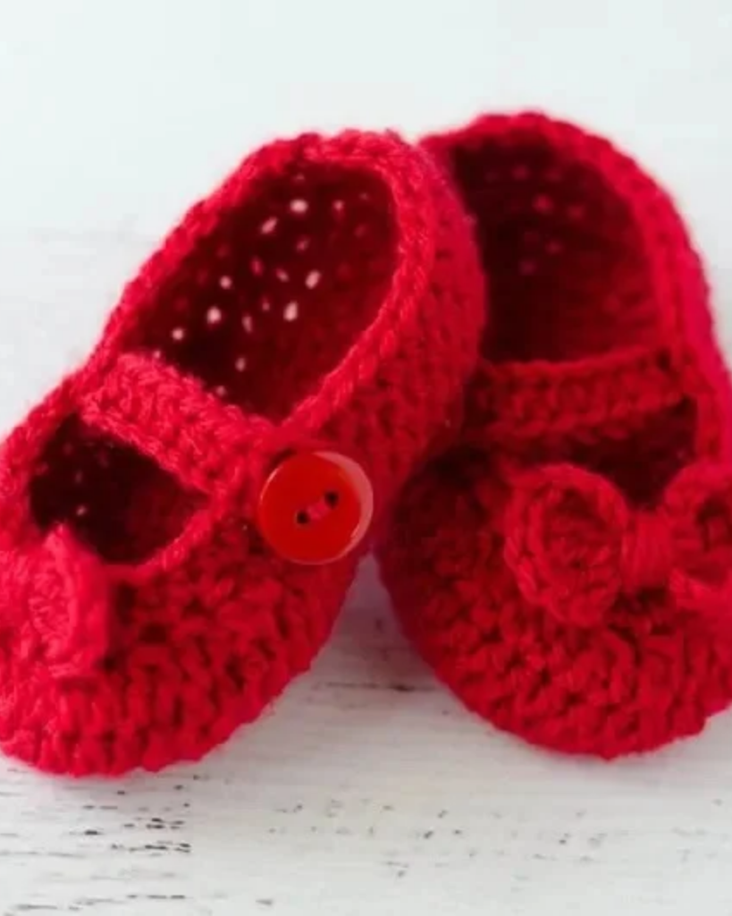 Crochet baby Mary Jane booties with a classic strap design.