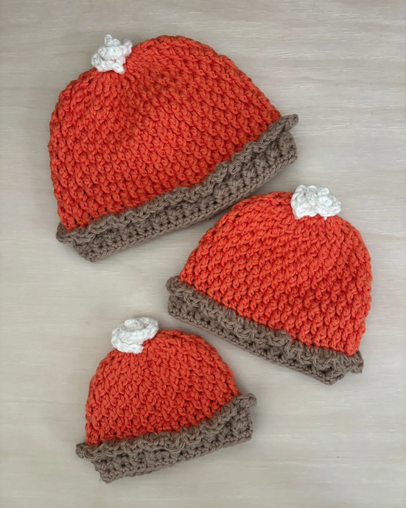 Crochet pumpkin pie baby hat with alpine stitch texture, pie-crust brim, and whipped cream topping.